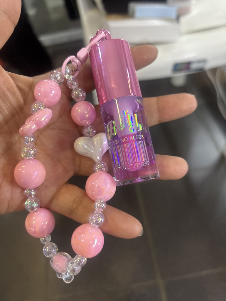 Lip gloss rosa con dije