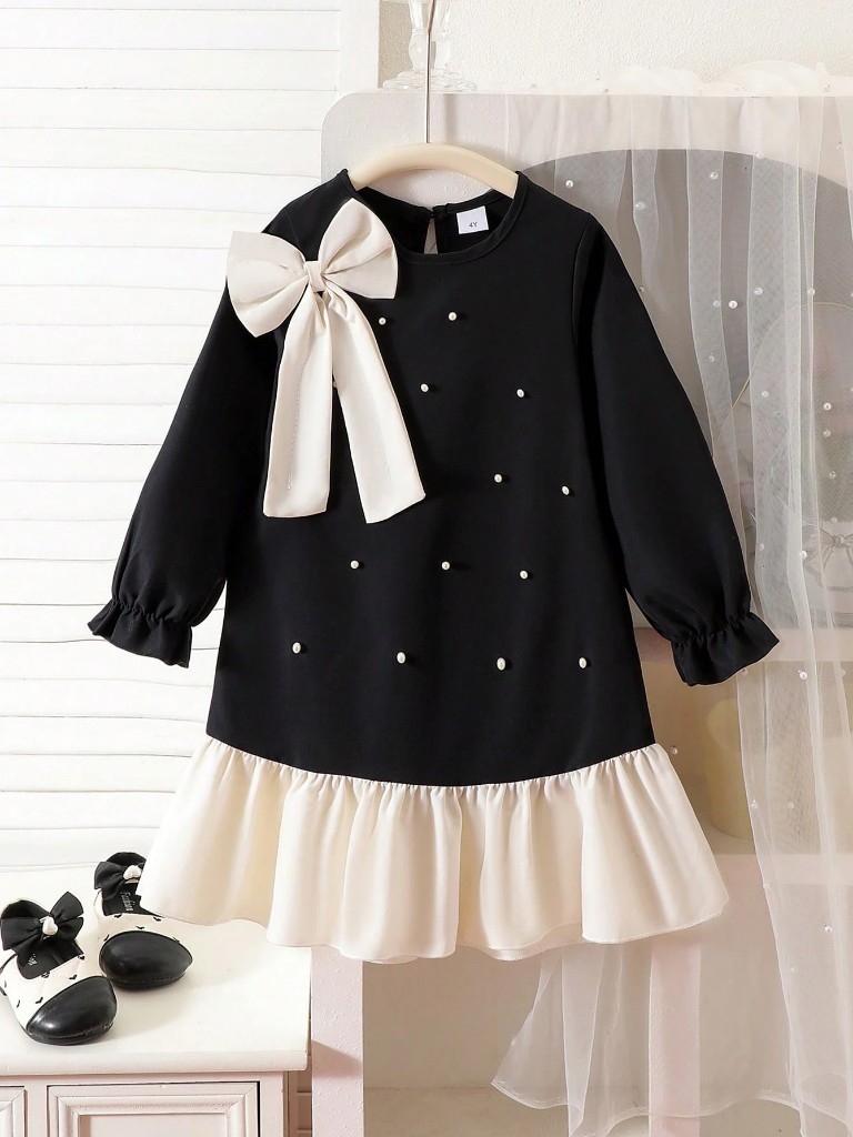 Vestido con parte inferior color crema y Parte superior negra con perlas incrustadas