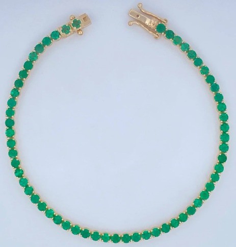 Pulcera tipo tennis con esmeraldas y oro 18k