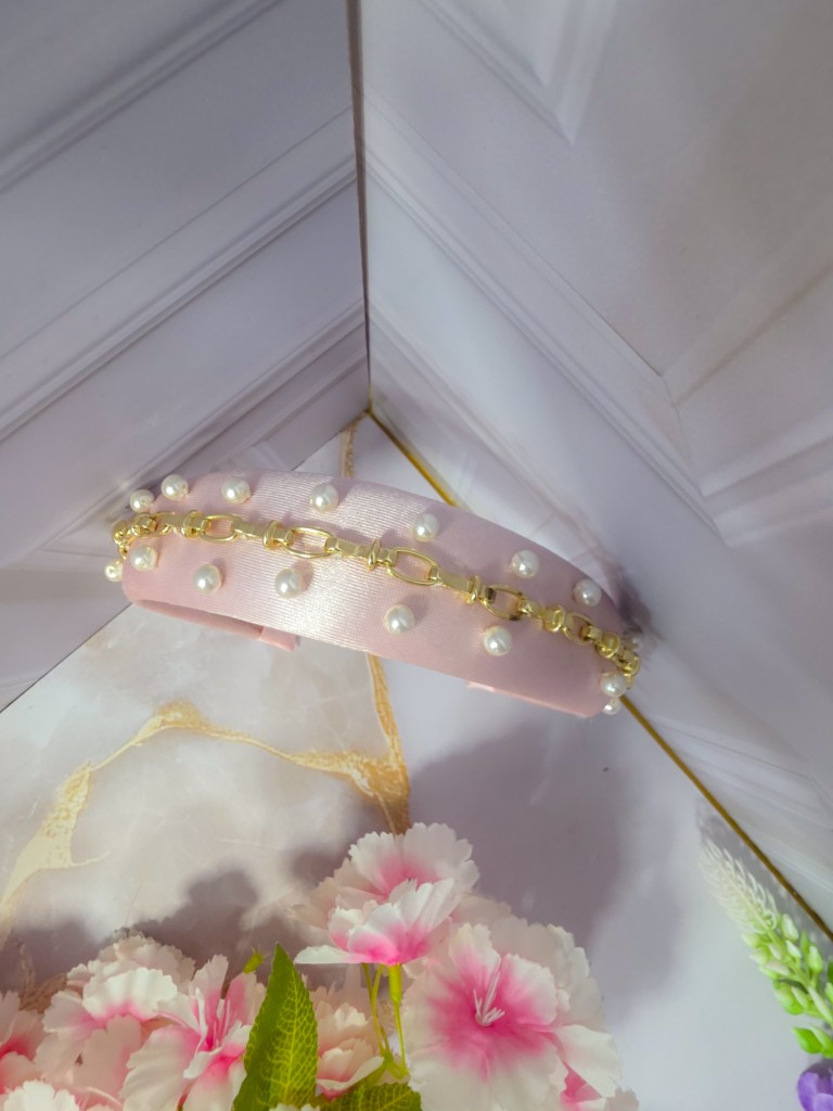Diadema rosa pálido con apliques de perlas y detalles dorados