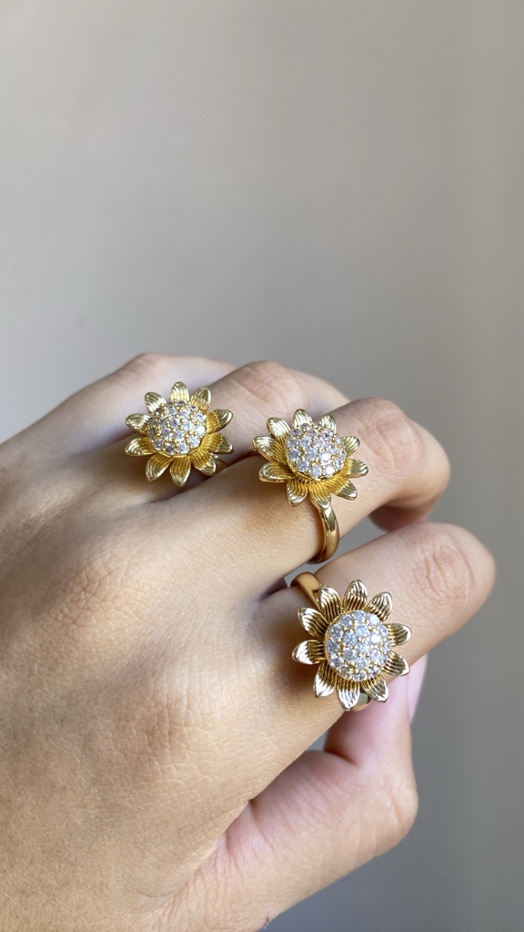 Anillo giratorio Margarita dorada con piedra blanca
