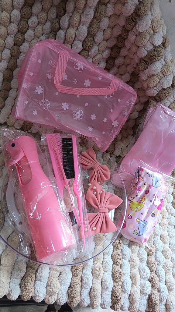 Set rosados de spray y peines