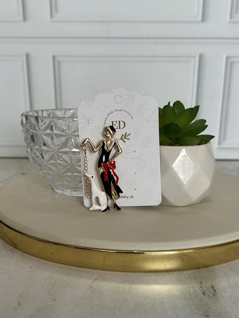 ED broche dorado y negro perro