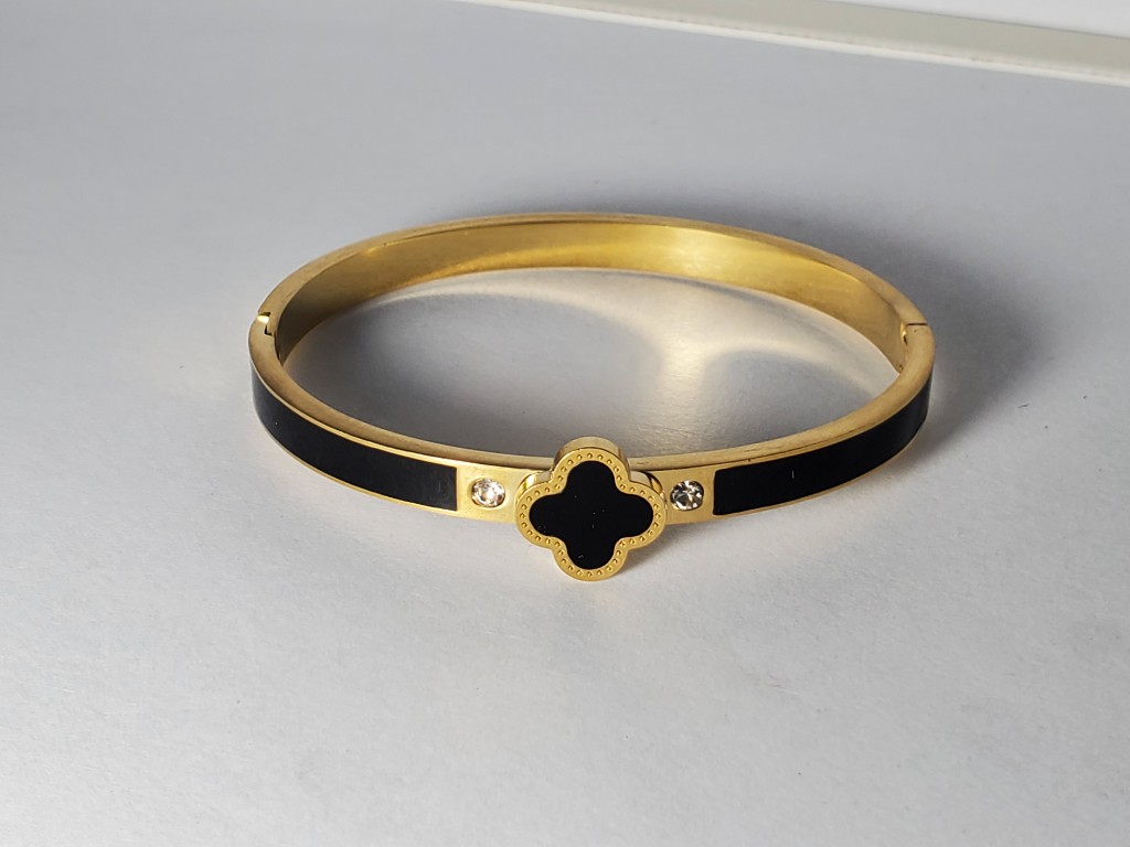 Pulsera dorada con rayas negras