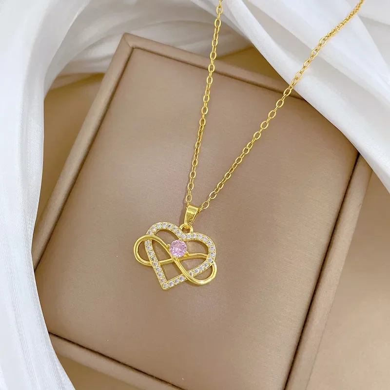 Collar de corazon infinito con circon rosado en el medio