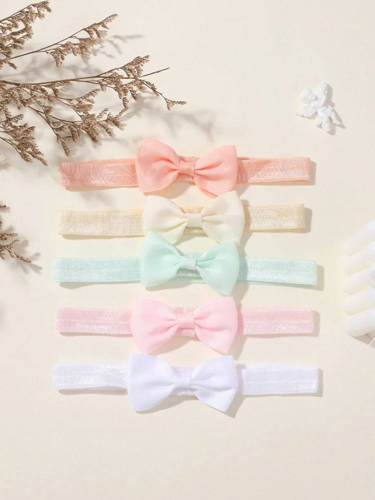 Cintillo de elastica con lazo en cinta blanco, rosado, verde agua, nude y salmon por unidad